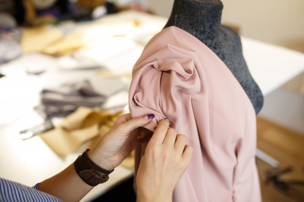 female-dressmaker-attach-fabric-mannequin-with-needles-creating-dress-design_105751-2873.jpg
